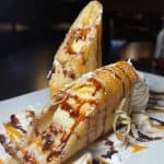 Fried Banana Cheesecake Egg Rolls - Fried egg rolls + banana + cheesecake + chocolate sauce + caramel sauce + whipped cream