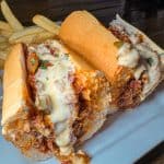 Smoked Brisket Cheesesteak - House-smoked brisket + sauteed peppers + onions + bourbon BBQ sauce + Cooper Sharp American cheese sauce + toasted
long roll