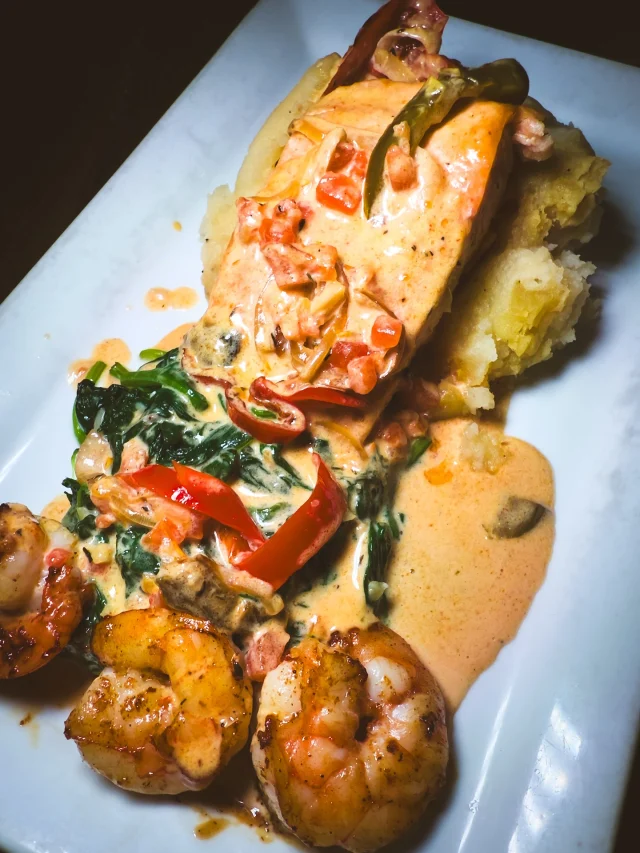 Sure, our smoked meats and short rib get all the fame… but this seafood? It’s coming for the crown.

Sautéed salmon stacked with blackened shrimp, jasmine rice, sautéed spinach, onions, and peppers, all swimming in rich Creole cream.

You didn’t see it coming… but now you can’t stop thinking about it.