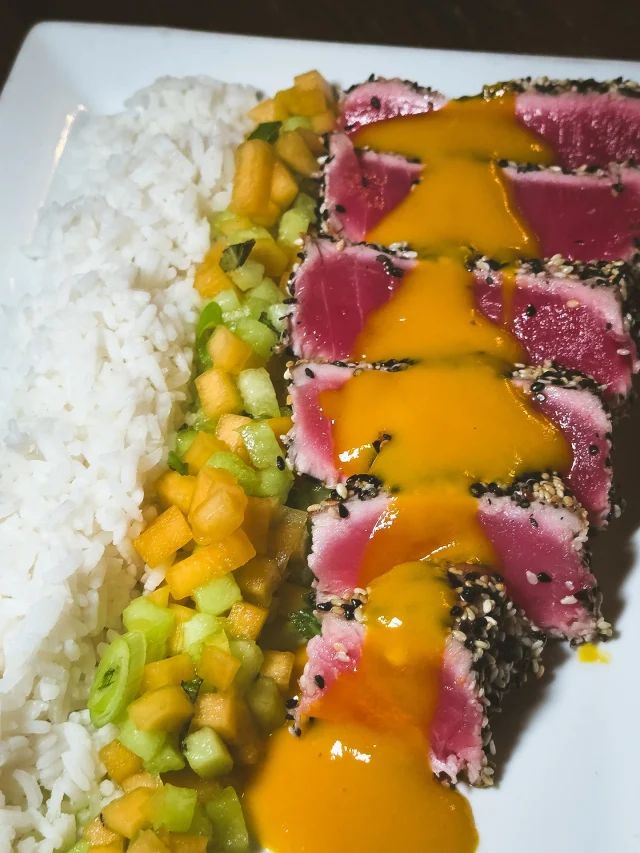 Craving seafood while everyone else is chasing smoke? We see you.

Our sesame-crusted seared tuna is buttery and bold, bringing the flavor with zero compromise. It’s served over jasmine rice, scallions, and a chilled Midori melon salad that keeps it light.

Finished with a jalapeño mango glaze for a sweet, spicy kick that holds its own next to any brisket.

For the seafood lovers who still want a seat at the smokehouse table.